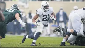  ?? THE ASSOCIATED PRESS ?? Penn State running back Noah Cain (21) rushes against Michigan State’s Jacub Pansiuk, left, during the first quarter of an NCAA college football game, Saturday, Oct. 26, 2019, in East Lansing, Mich. Penn State running back Noah Cain will miss the rest of the season with an injury, another blow to the the 18th-ranked Nittany Lions’ backfield as they prepare to face No. 3 Ohio State.