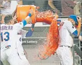  ?? N.Y. Post: Charles Wenzelberg (5) ?? SPLASHDOWN: Wilmer Flores and Asdrubal Cabrera dump Gatorade on Jose Bautista after his walk-off grand slam lifted the Mets over the Blue Jays 5-1. That gave Jacob deGrom (top), who pitched another gem, the rare satisfacti­on of seeing his team win a...