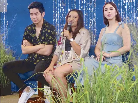  ??  ?? Director Antoinette Jadaone (center) with her lead stars Joshua Garcia and Julia Barretto at a press conference for Love You To The Stars And Back opening nationwide on Aug. 30