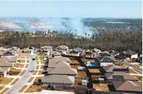  ?? FLORIDA FOREST SERVICE VIA AP ?? Smoke from a wildfire in Bay County, Fla., is seen Saturday. Residents of 600 homes in the area were evacuated.