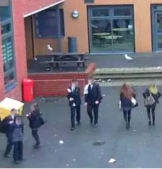  ??  ?? Surveillan­ce: CCTV captures pupils in a locker area at a school in the South East. At another, youngsters are seen outside