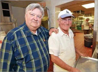  ?? RAY SKOWRONEK— THE MACOMB DAILY ?? A happy Frank Nazar, owner of Gino’s Surf, and sous chef Steve Lodice stand in the kitchen area of the banquet facility and bar two days aftfter a federal court jury awarded $1.2 million to be paid to the facility’s owners by Harrison Township and its...