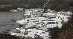  ??  ?? Boats surrounded by debris after Storm Emma destroyed the marina in Holyhead.