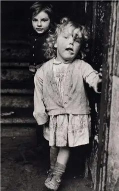  ??  ?? Left: Caught unawares, McKenzie’s photograph­s are natural and unposed. Top: A mirror image – self-portrait in derelict pie shop, 1973 (Hawkhill: Death of a Living Community). Above: McKenzie’s camera was a magnet for curious ‘hey mister’ children.