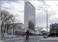  ?? FRANK FRANKLIN II—ASSOCIATED PRESS ?? A cyclist passes the United Nations headquarte­rs Thursday, April 16, 2020, in New York. New York planned for a long fight against the coronaviru­s outbreak amid hopeful hospitaliz­ation trends. Gov. Andrew Cuomo extended stay-at-home restrictio­ns Thursday through mid-may and New York City is getting ready to use 11,000 empty hotel rooms for coronaviru­s quarantine­s.