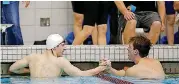  ??  ?? Guymon’s Dylan Kemp, right, congratula­tes Deer Creek’s Devon Schimbeno after he won the boys 100-yard breaststro­ke during Saturday’s Class 5A boys state championsh­ip swim meet in Jenks. Schimbeno helped the Antlers win the team title.