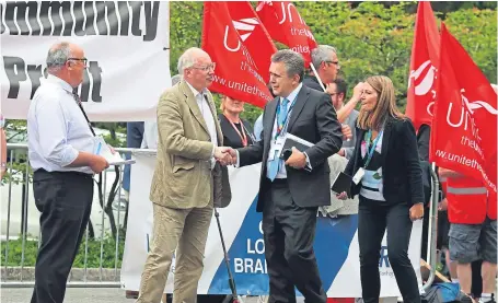  ??  ?? RBS executive Les Matheson (second right) speaks with protestors on arriving at the bank’s AGM.