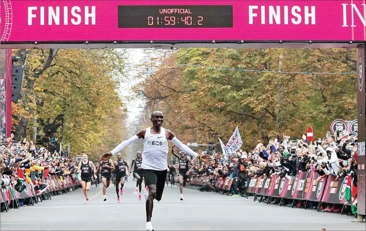  ?? AFP ?? Kenyan Eliud Kipchoge broke the two-hour marathon mark with a pair of Nike trainers that have competing companies crying foul.