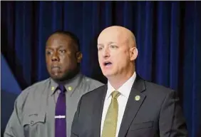  ?? Will Waldron / Times Union ?? State Police Lt. Robert Appleton discusses arrests in a June 9 slaying with Maj. R. Christophe­r West, seen on the left, at Troop G Headquarte­rs.