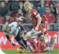  ??  ?? Adama Traore of Middlesbro­ugh is challenged by Horour Magnusson of Bristol City