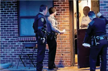  ?? [PHOTOS BY STEVE GOOCH, THE OKLAHOMAN] ?? Oklahoma City police officers Billy Robison, left, Joshua Gershon and Eric Gengnagel talk with a resident in northeast Oklahoma City.