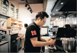  ??  ?? Café owner Kim Jeong-il prepares a latté at his coffee shop in Jeonju, South Korea. Pictures: Reuters/Kim Hong-Ji