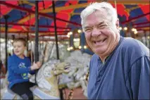  ?? STEPHEN SPILLMAN / FOR AMERICAN-STATESMAN ?? Charlie Ford speaks to his visitors in January as they ride the Kiddie Acres carousel he restored in his North Austin backyard. He’ll run that carousel again Saturday.