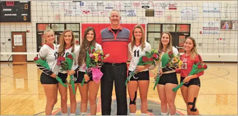 ?? Daniel Bell ?? The senior members of the Sonoravill­e Lady Phoenix volleyball team pose for a picture with Coach Trace Vaughn.