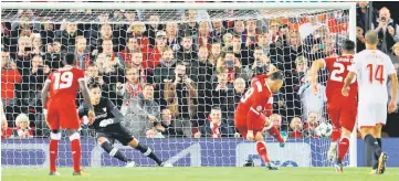  ??  ?? Liverpool’s Roberto Firmino misses the penalty during the UEFA Champions League Group E match against Sevilla at Anfield in Liverpool, north-west England. — Reuters photo