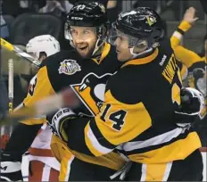  ?? Peter Diana/Post-Gazette ?? Nick Bonino, left, didn’t play Tuesday against the Hurricanes because of an illness.