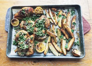  ?? Elizabeth Karmel / Associated Press / AP ?? Roasted chicken, potato wedges and green peas can be prepared in an all- in- one- pan method.