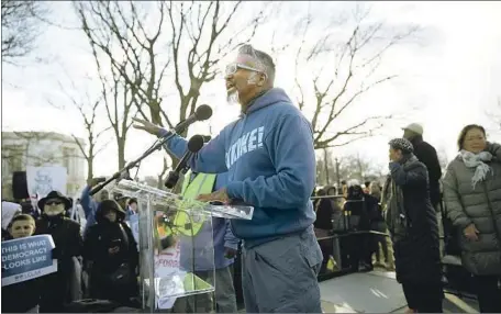  ?? ACTIVISTS LIKE Alex Wong Getty I mages ?? Joseph Geevarghes­e, at a 2017 rally, are easing up on Joe Biden only while he campaigns to oust President Trump.