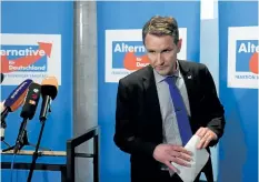  ?? HENDRIK SCHMIDT/GETTY IMAGES ?? Bjoern Hoecke, leader of the Alternativ­e for Germany party in the eastern state of Thuringia, leaves after giving a statement on Monday at the Thuringian regional parliament in Erfurt, Germany. The party is moving to expel Hoecke, who argued the...