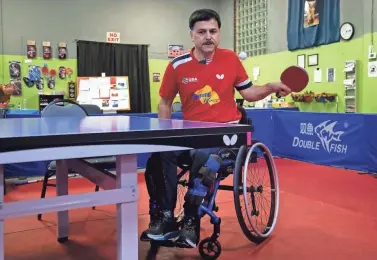  ?? NICOLAS GALINDO/COLUMBUS DISPATCH ?? Ahad Sarand plays table tennis at the Columbus Table Tennis Club last week. Sarand, an Iranian immigrant, plays table tennis for Team USA in the Paralympic­s and represents the United States in internatio­nal competitio­ns.