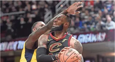  ?? DAVID RICHARD/ USA TODAY SPORTS ?? LeBron James, right, lost a Game 1 of a first-round playoff series for the first time in 12 years. James and the Cavaliers fell to Lance Stephenson, left, and the Pacers 98-80 Sunday in the Eastern Conference playoffs.