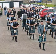  ??  ?? Drum Major Liam Renton leads the march to the first tee at Machrihani­sh, where the opening ceremony was held.