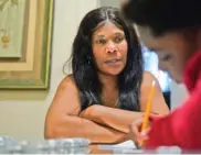  ?? AP PHOTO/STEVEN SENNE ?? Evena Joseph, left, sits with her son, J. Ryan Mathurin, 9, as he does his homework Dec. 22 at their home in Boston.