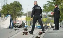  ?? JOE CAVARETTA/SOUTH FLORIDA SUN SENTINEL ?? Hollywood police work the scene of a deadly crash on Pembroke Road just west of Park Road on Tuesday. A person riding a scooter was killed.