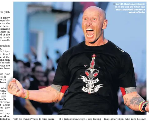  ??  ?? > Gareth Thomas celebrates as he crosses the finish line at last weekend’s Ironman event in Tenby