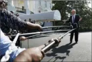  ?? JACQUELYN MARTIN — ASSOCIATED PRESS ?? President Donald Trump speaks to the media as he walks to the Marine One helicopter on the South Lawn of the White House in Washington on Friday.