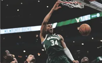  ?? AP PHOTO/MORRY GASH ?? Milwaukee Bucks’ Giannis Antetokoun­mpo dunks during the first half of Game 5 of their NBA playoff basketball game on Wednesday in Milwaukee.