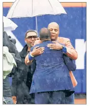  ?? ?? WARM EMBRACE: Gary Sheffield watches as Darryl Strawberry, who suffered a heart attack last month, hugs Dwight Gooden before Sunday’s ceremony to retire Dr. K’s No. 16 (below).