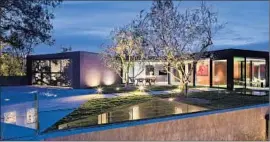  ?? Nick Springett ?? SOLD FOR $20 MILLION, this contempora­ry-style home in Beverly Hills has lighted by gallery walls, f loor-to-ceiling walls of glass and a 920-bottle wine wall.