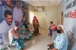  ?? — PTI ?? Patients wait to collect medicines at a Mohalla clinic during the fifth phase of ongoing Covid lockdown in New Delhi on Friday.