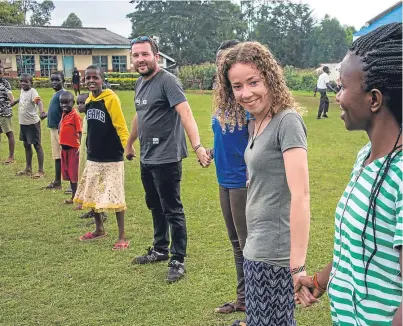  ??  ?? Shona (second from right) loved interactin­g with children and adults in the Kenyan town of Yala.