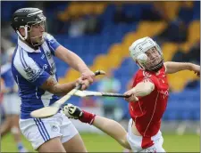  ??  ?? Eire Og’s Anthony Byrne gets his shot away despite the efforts of Glenealy’s Ruairi O’Neill. Photos: Garry O’Neill