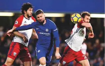  ?? AP ?? Chelsea’s Oliver Giroud (centre) vies for the ball with West Bromwich Albion’s Ahmad Hegazi (left) and Craig Dawson during the Premier League match at Stamford Bridge stadium.