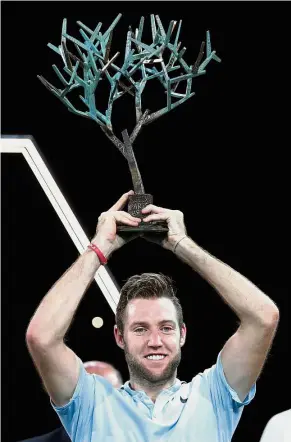  ??  ?? Just wonderful: Jack Sock holding aloft his trophy after defeating Filip Krajinovic in the Paris Masters final on Sunday. — Reuters