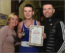  ??  ?? Holy Family BC’s Liam Mc Cormack, the Boy 3 72kg champion, celebrates with his mum Eileen and dad Dave.