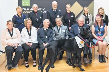  ?? PHOTO: LINDA ROBERTSON ?? Just reward . . . Otago Kiwibank Local Heroes (back, from left) Rosalie Goldsworth­y, Alan Green, John Darby, Dr Lynnette Jones, Tam Schurmann, Tanya Findlater, and (front, from left) Kayla McNamara, Pippa Wellstead, Maurice Hayward, Peter Chin, Sir Tim Wallis and Colleen Symon with Spook.