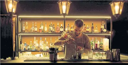  ?? ANDREA WYNER THE NEW YORK TIMES ?? A bartender prepares a drink at Auberge, a cozy Lugano bistro that features items like salads, ceviches and tuna and shrimp tartar.