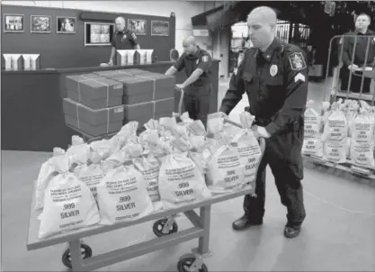  ??  ?? NEW YORK RESIDENTS CASH IN: It’s like a modern day Gold Rush. Everyone’s scrambling to get their hands on the heavy, Jumbo Silver Ballistic Bags pictured above before they’re all gone. That’s because residents who find their zip code printed in today’s publicatio­n are cashing in on the lowest ever State Minimum price set for the next 2 days by the Federated Mint.