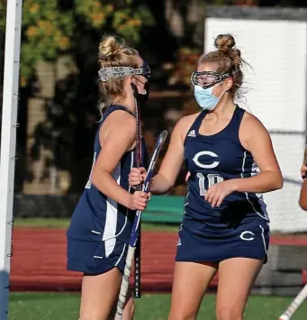  ??  ?? JOB WELL DONE: Kate Cunning (left) and Piper Finn celebrate Cunning’s goal against Bishop Fenwick yesterday.