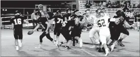  ?? MARK HUMPHREY ENTERPRISE-LEADER ?? Prairie Grove Junior High quarterbac­k Paytin Higgins hands off to Ethan Miller. junior Tigers suffered a 28-14 setback against Shiloh Christian on Sept. 27.