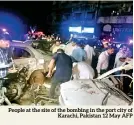  ?? ?? People at the site of the bombing in the port city of Karachi, Pakistan 12 May AFP