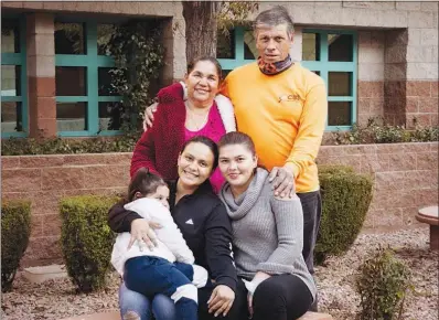  ?? YASMINA CHAVEZ ?? Clockwise from top left, Jorge Escobar de Guillen, Santos Guillen Hernandez, Karla Elizabeth Guillen Escobar, Ana Guillen and her daughter Daniela pose Dec. 14, 2020, for a photo at Catholic Charities of Southern Nevada. With the help of Catholic Charities, Hernandez was reunited with his wife, Jorge, and youngest daughter, Karla, after being separated for 22 years.