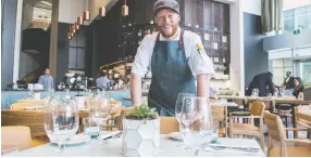  ??  ?? Chef de cuisine Jason Greene runs the kitchen at Kindred Food and Drink in the J.W. Marriott hotel.