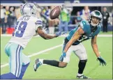 ?? Michael Ainsworth / Associated Press ?? Dallas’ Amari Cooper catches a ball tipped by Philadelph­ia’s Rasul Douglas before scoring the game-winning touchdown in the Cowboys’ 29-23 overtime win. The win gives Dallas a two-game lead in the NFC East with three games to play.