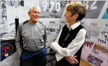  ?? PHOTOS BY HYOSUB SHIN / HSHIN@AJC.COM ?? Top: Atlanta Track Club unveiled a traveling display Friday in Lenox Square on the history, legends and legacy of the world’s largest 10K just feet from the Peachtree start line. Above: Bill Thorn, the only person to complete every running of the Peachtree, chats with Julia Emmons, longtime race director.