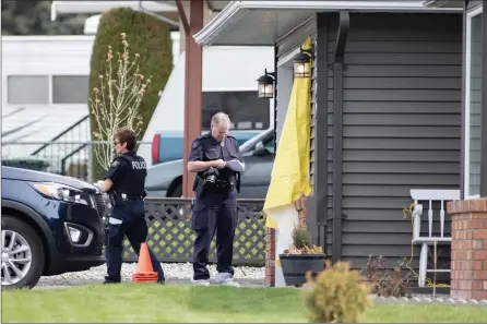  ?? The Canadian Press ?? RCMP officers work outside a crime scene on Cornwall Drive in Penticton on April 16, 2019. Retired city employee John Brittain apologized Thursday in a Kelowna courtroom for shattering the lives of emergency workers, victims’ families and his ex-wife, Kathy Brittain.